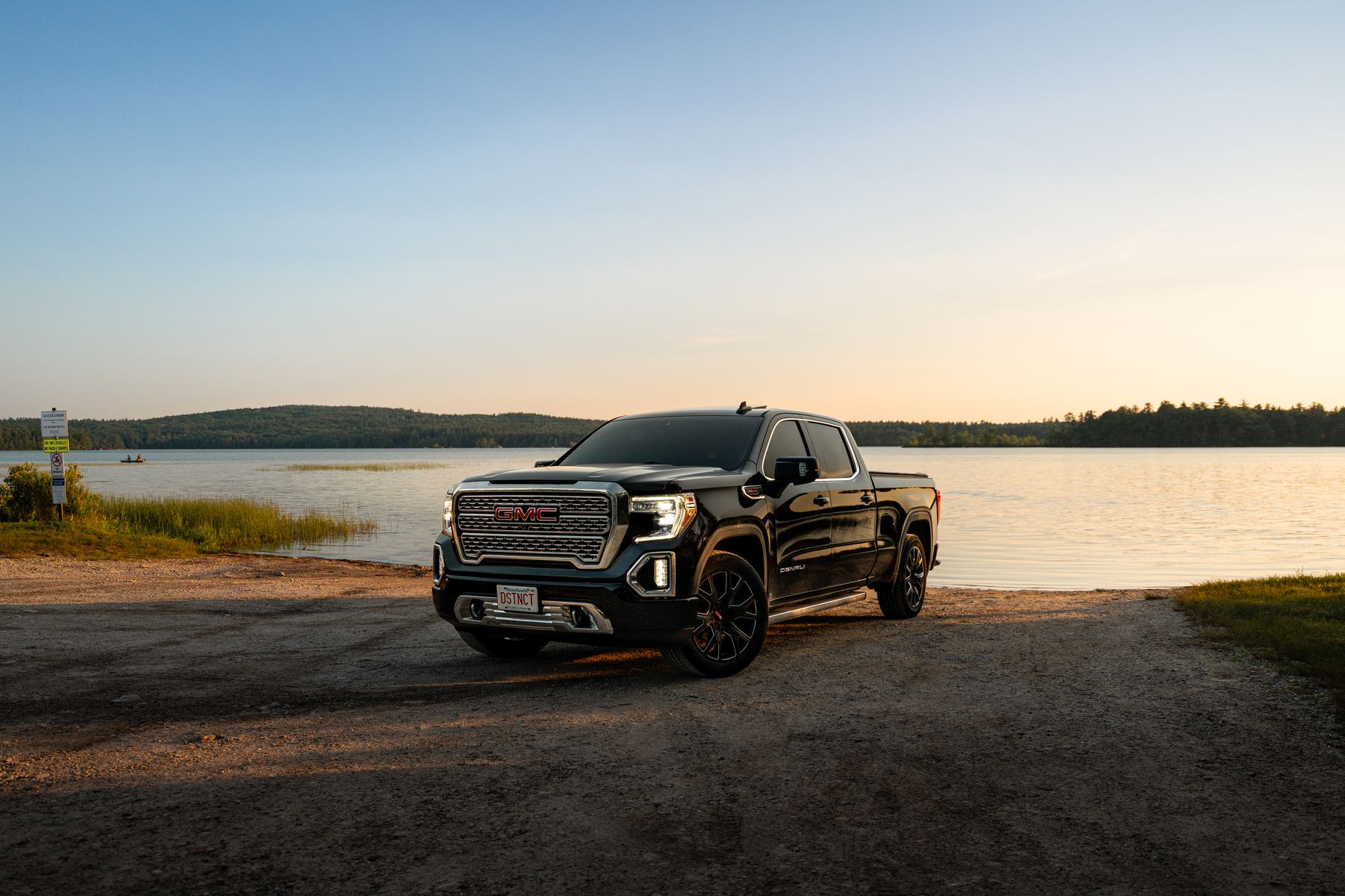 Black GMC Denali pickup photographed at a New Hampshire lake at golden hour, client automotive shoot