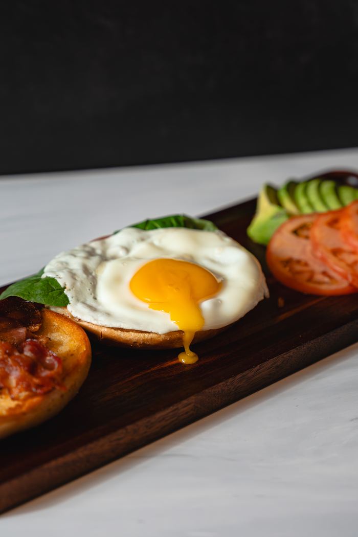 Frame: fried-egg breakfast sandwich on a roll